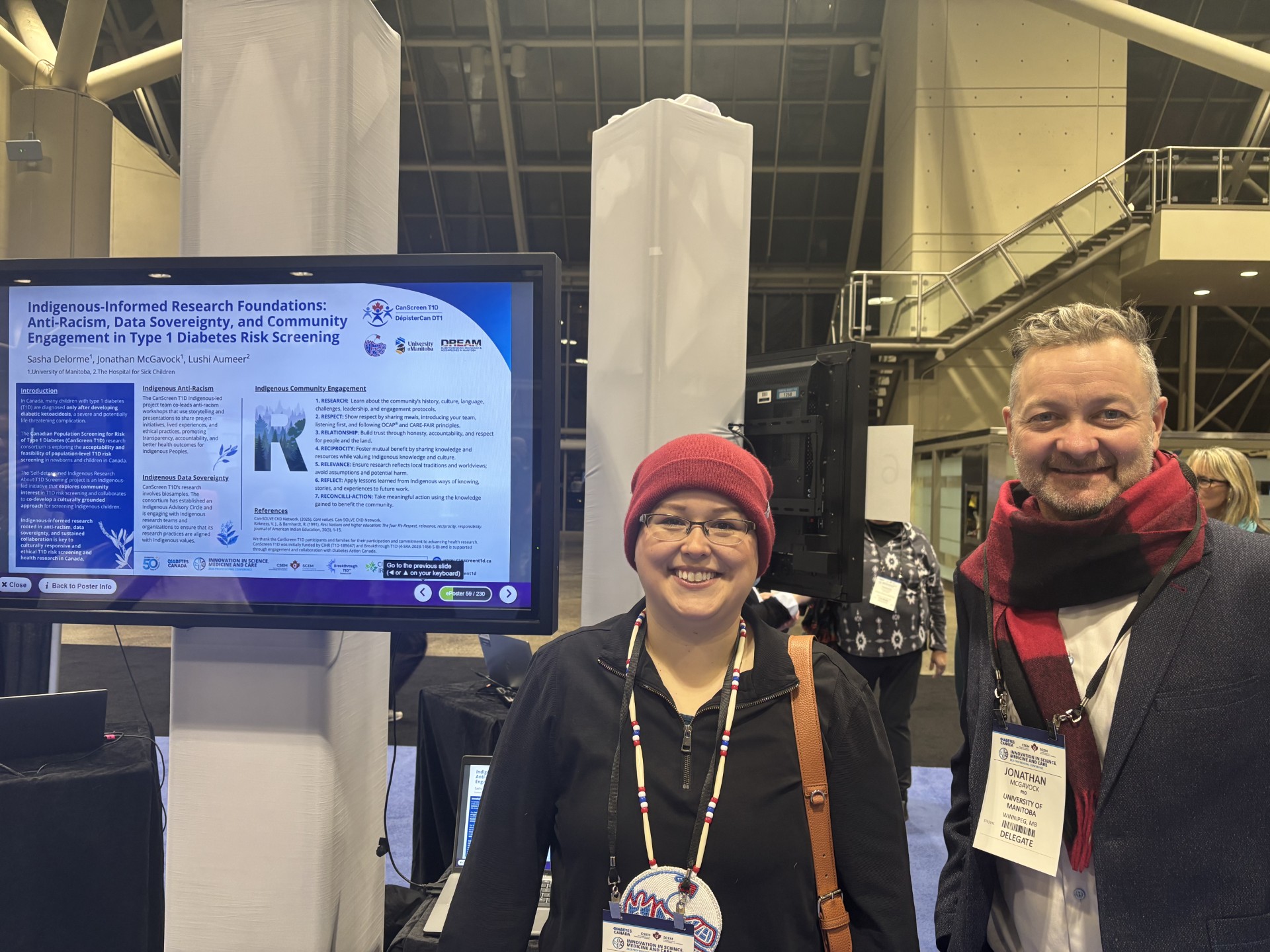 Sasha Delorme and Jon McGavock standing in front of their research poster at the Diabetes Canada Conference